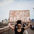 photo of woman carrying a cardboard